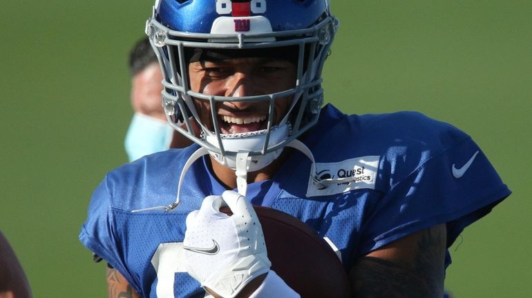 Giants tight end Evan Engram (88) laughs as he walks...