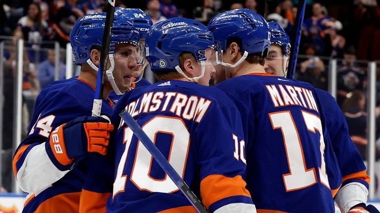 Simon Holmstrom of the Islanders celebrates his third-period goal against the...