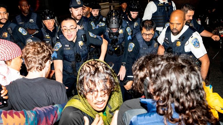 Demonstrators clash with the Metropolitan Police Department officers at George...