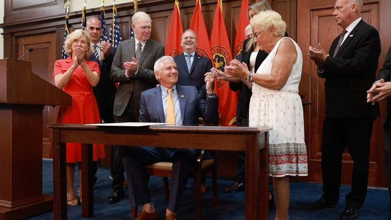 Nassau County Executive Bruce Blakeman celebrates with supporters Monday after signing...