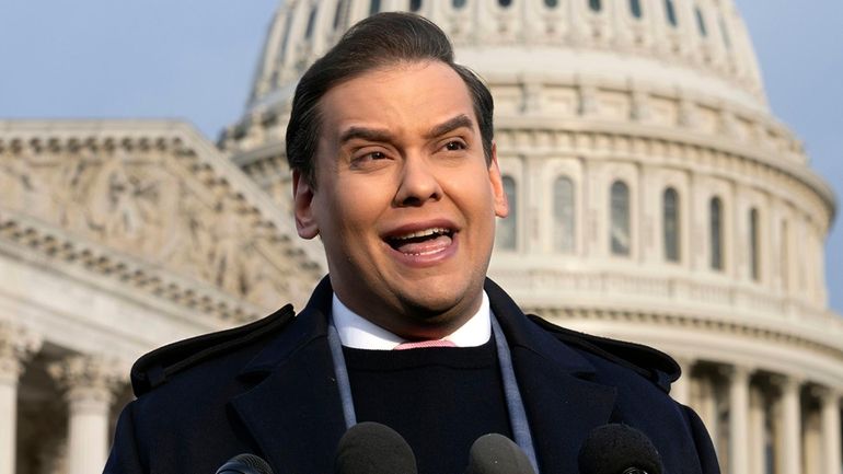 Then-Rep. George Santos talks to reporters at the U.S. Capitol in Washington on Nov....