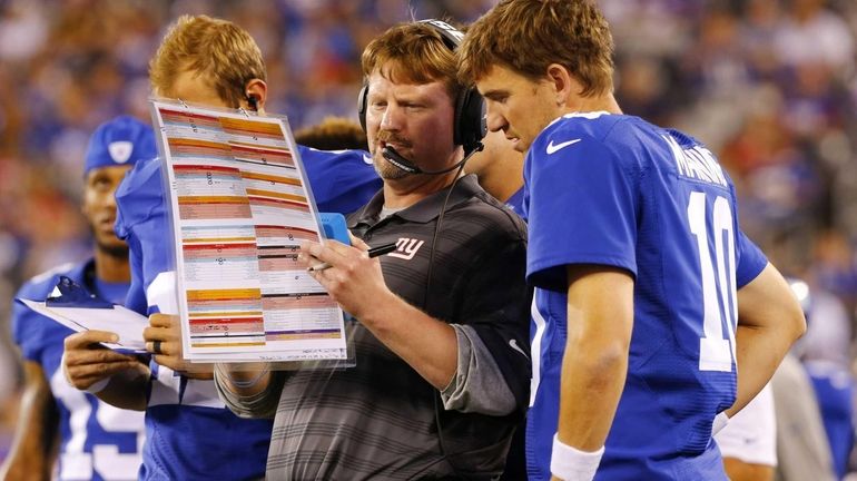 Offensive coordinator Ben McAdoo of the Giants goes over a...