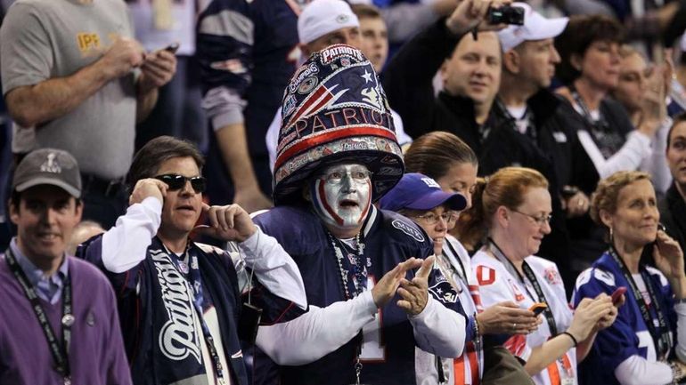 Fans watches warm-ups on the field before the New England...