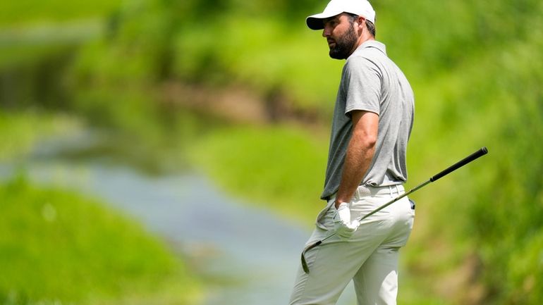 Scottie Scheffler waits to play on the second hole during...