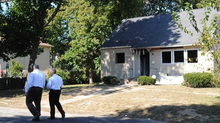 Suffolk County police detectives in front of home at 25...