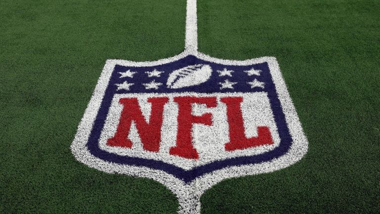 The NFL logo is shown on the field before an...