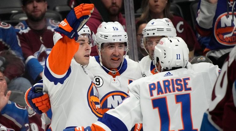 Islanders center Jean-Gabriel Pageau, left, celebrates his goal against the...