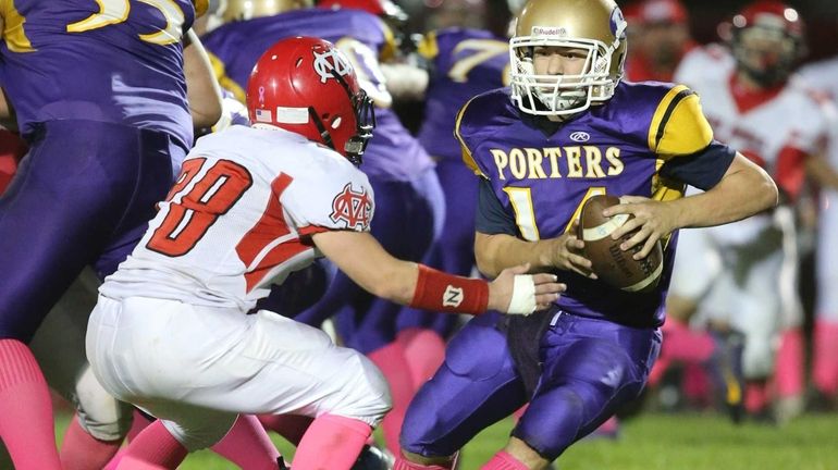 Greenport/Southold/Mattituck quarterback Matt Drinkwater keeps the ball on an option...