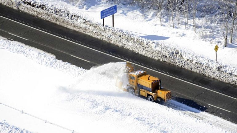 Snow is plowed on the LIE between exits 65 and...