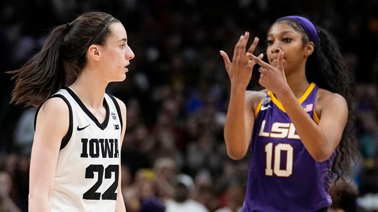 FILE -LSU's Angel Reese reacts in front of Iowa's Caitlin...