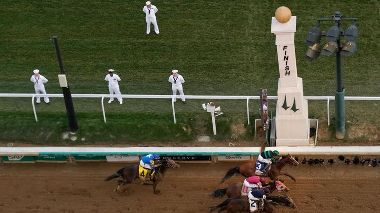 Brian Hernandez Jr. rides Mystik Dan, top right, to the...