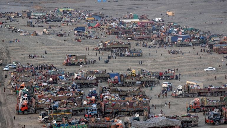 FILE- Afghan refugees settle in a camp near the Torkham...