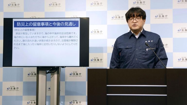 An official for the Japan Meteorological Agency speaks during a...