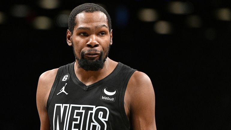 Nets forward Kevin Durant looks on against the Bucks in...