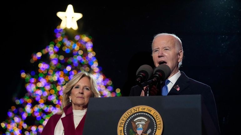 President Joe Biden speaks as first lady Jill Biden listen...