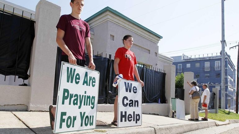 In this photograph, anti-abortion advocates stand outside Mississippi's only abortion...