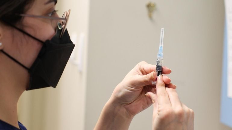 Registered nurse Wendy Gonzalez prepares a flu shot at Huntington...