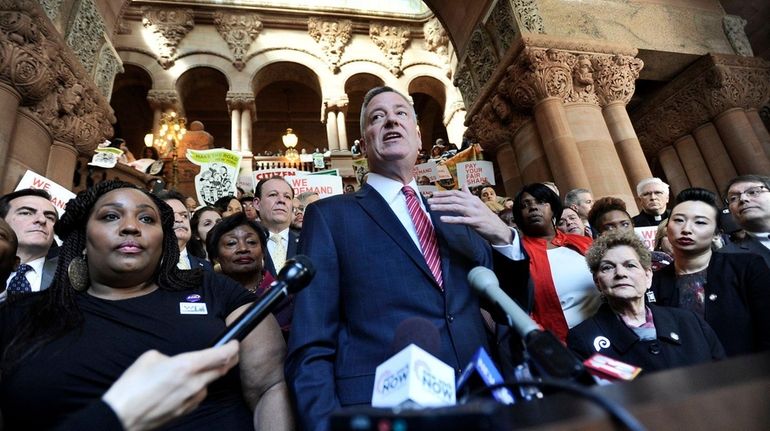 New York City Mayor Bill de Blasio speaks with lawmakers...