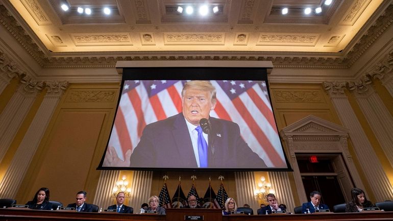 An image of former President Donald Trump is displayed during...