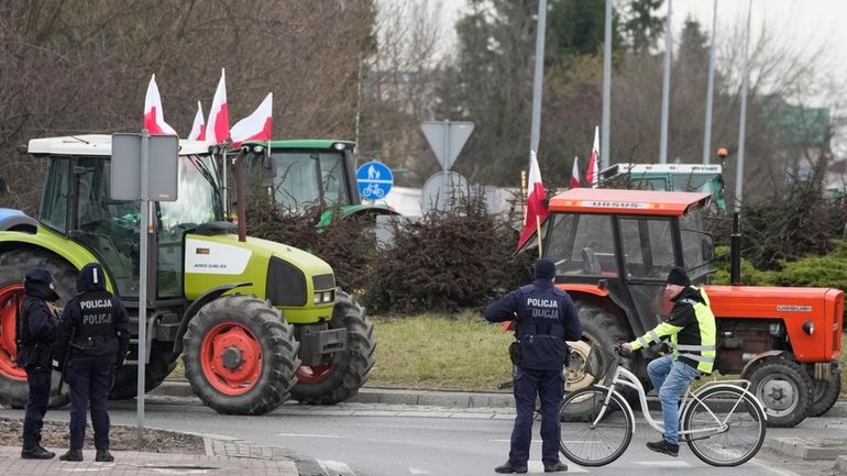 Polish farmers drive tractors in a convoy as they intensify...