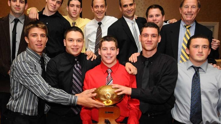 Sayville coaches and players pose for a portrait after receiving...