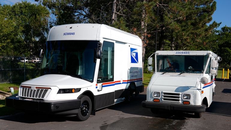 The U.S. Postal Service's next-generation delivery vehicle, left, is displayed...