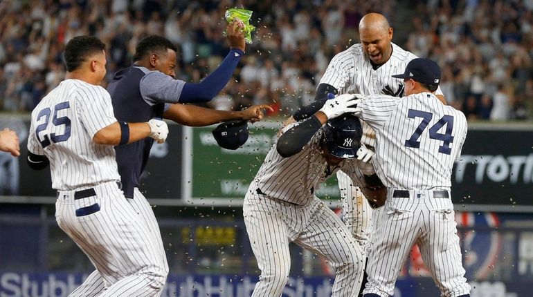 Miguel Andujar of the Yankees celebrates his ninth-inning game-winning base...