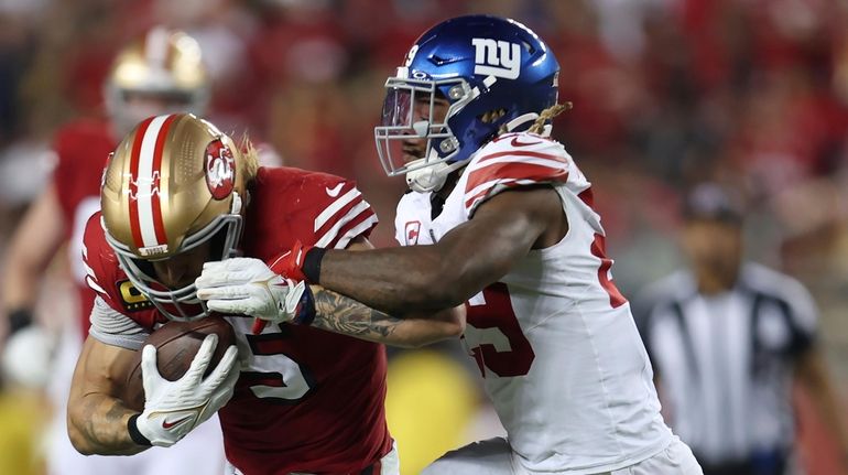 San Francisco 49ers tight end George Kittle, left, runs against Giants...