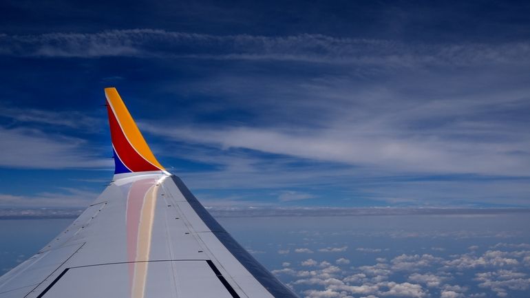 A Southwest Airlines Boeing 737 Max 8 passenger jet flies...