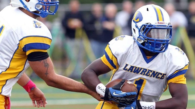 Lawrence's QB Joe Capobianco hands the ball to Jordan Fredericks...