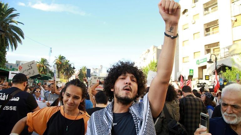 Tunisian take part in a protest against President Kais Saied...