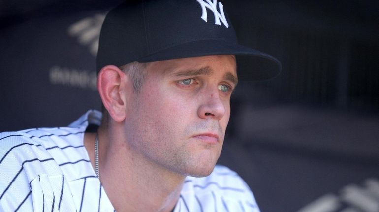 Yankees pitcher James Paxton reacts in the dugout after being...