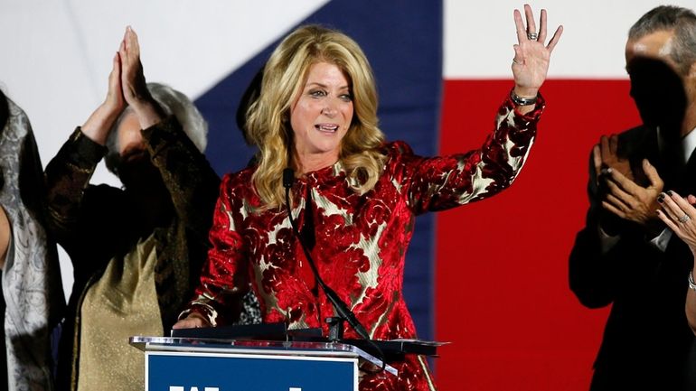 Then-Texas Democratic gubernatorial candidate Wendy Davis waves to supporters after...