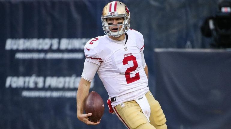 Quarterback Blaine Gabbert #2 of the San Francisco 49ers carries...