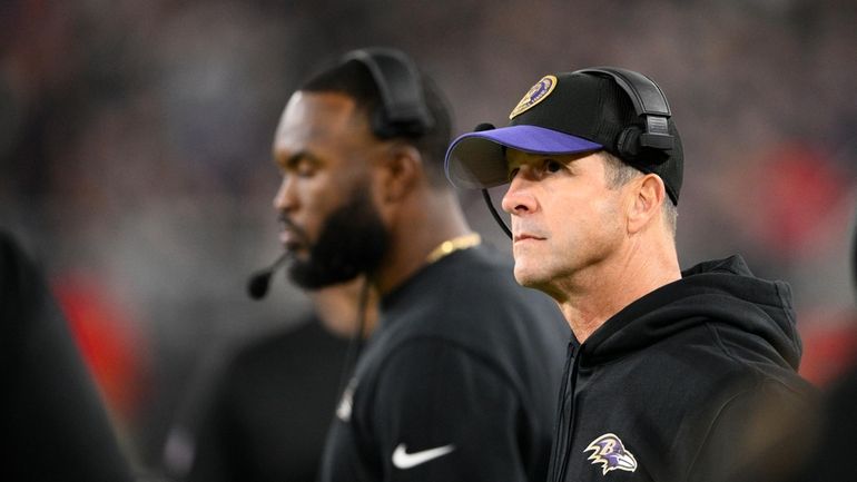 Baltimore Ravens coach John Harbaugh looks onto the field in...