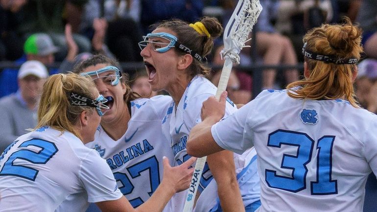 North Carolina attacker Sam Geiersbach, center, shouts with Ally Mastroianni,...