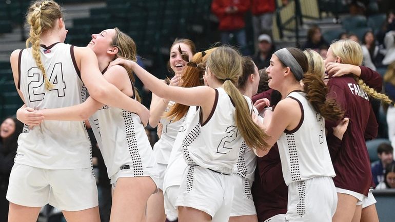 Madison Schultz #5 of Kings Park, second from left, hugs...