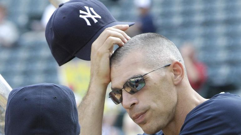 New York Yankees manager Joe Girardi takes off his cap...