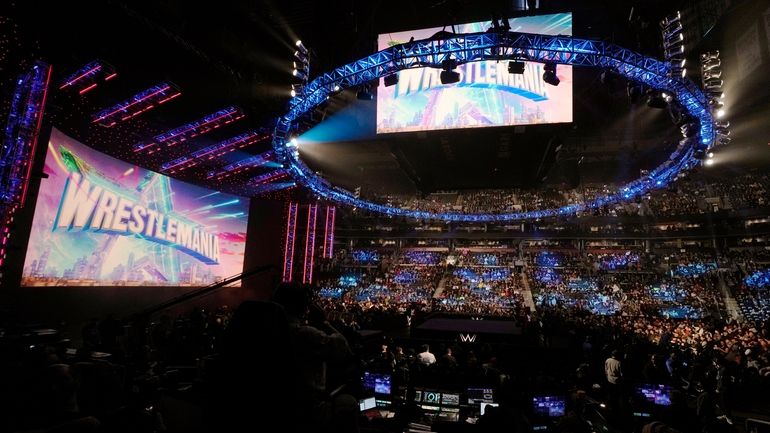A WrestleMania sign hangs over the crowd during a WWE...