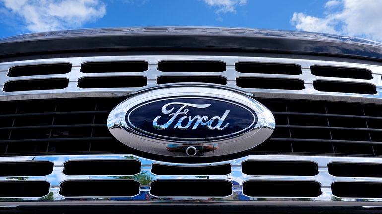 The Ford logo is shown on the grill of a...