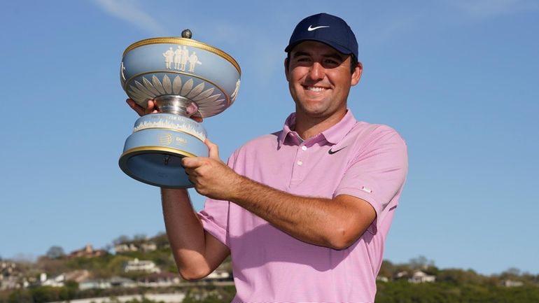 Scottie Scheffler holds the trophy after winning the Dell Technologies...