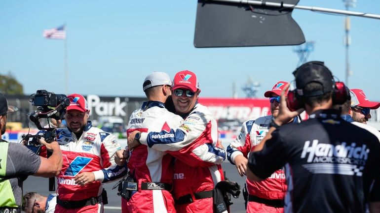 Crew members celebrate after Kyle Larson won a NASCAR Cup...