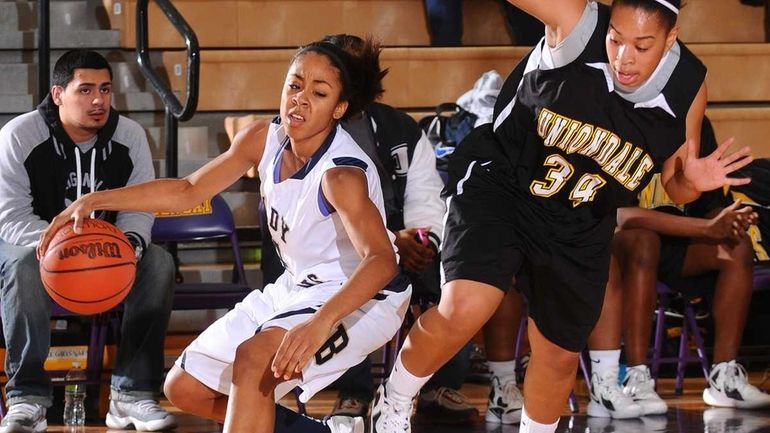 Baldwin High School #4 Alex Hampton, left, looks to get...