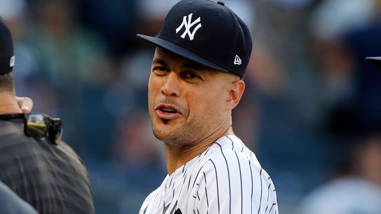 Giancarlo Stanton #27 of the Yankees looks on after a game...