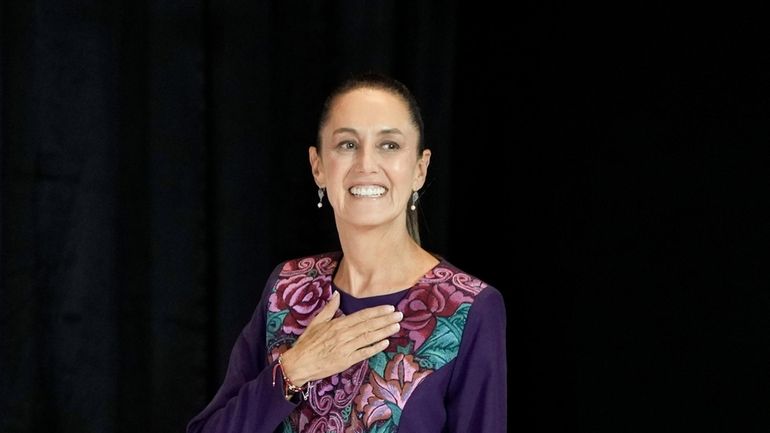 Ruling party presidential candidate Claudia Sheinbaum waves as she arrives...