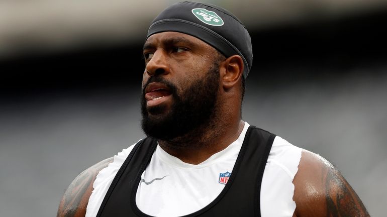 Jets offensive tackle Duane Brown  warms up before a game against...