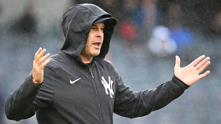 Yankees manager Aaron Boone approaches an umpire during the eighth...