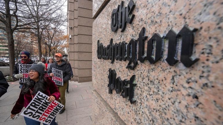 Employees of the Washington Post picket outside the company's offices...