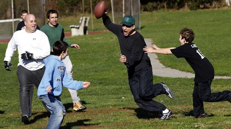 Rich Steinberg (with football) runs back a pass intended for...