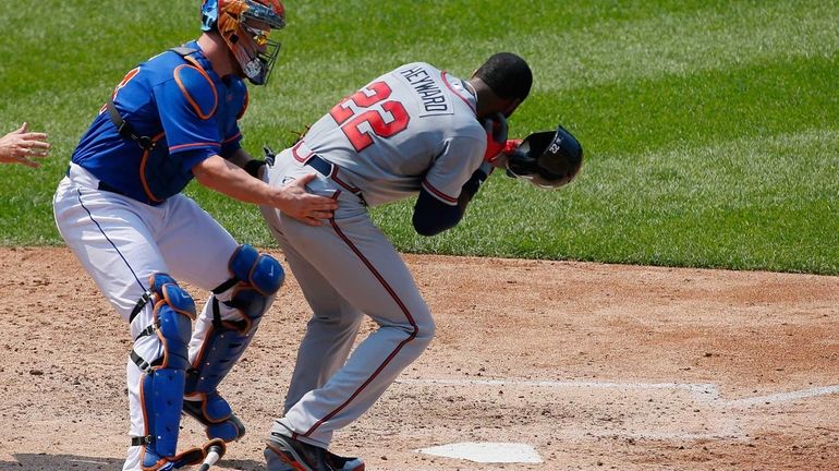 Atlanta Braves outfielder Jason Heyward is helped by John Buck...